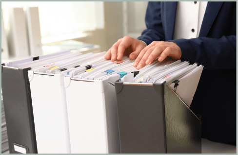 Professional operating a high-volume office copier in a production environment, representing DigiSource's document management and production capabilities.