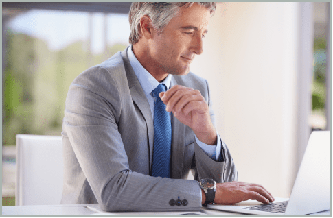 Professional operating a high-volume office copier in a production environment, representing DigiSource's document management and production capabilities.