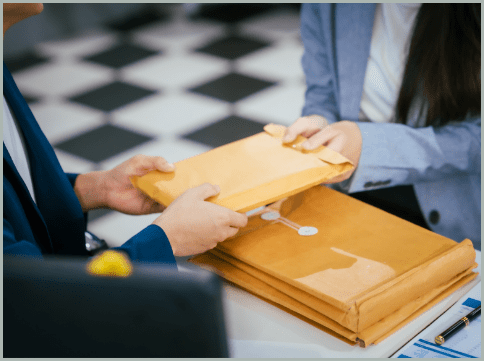 Documents being organized and handled as part of a controlled document processing workflow.