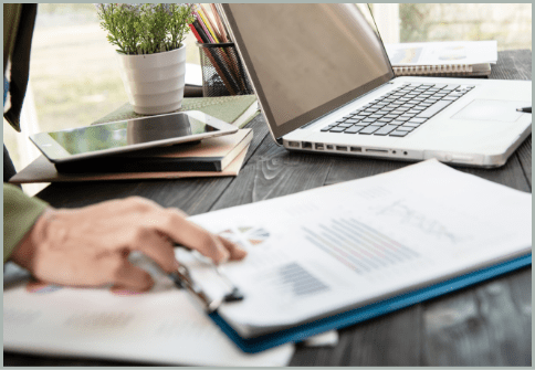 Professional using a laptop to analyze information, representing data processing, analytics and electronic discovery workflows.