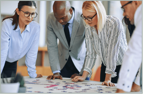 Business professionals collaborating to solve a complex project