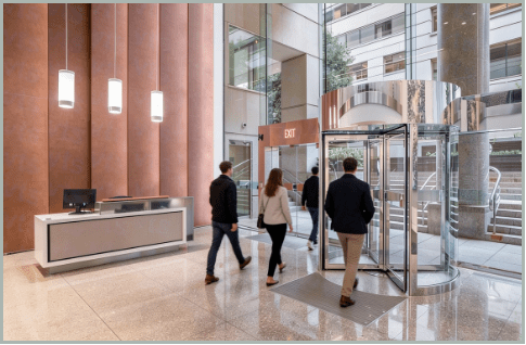 Professionals walking through a modern office building lobby